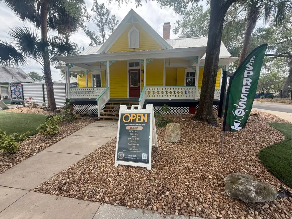 yellow house sign at Cafe THCA